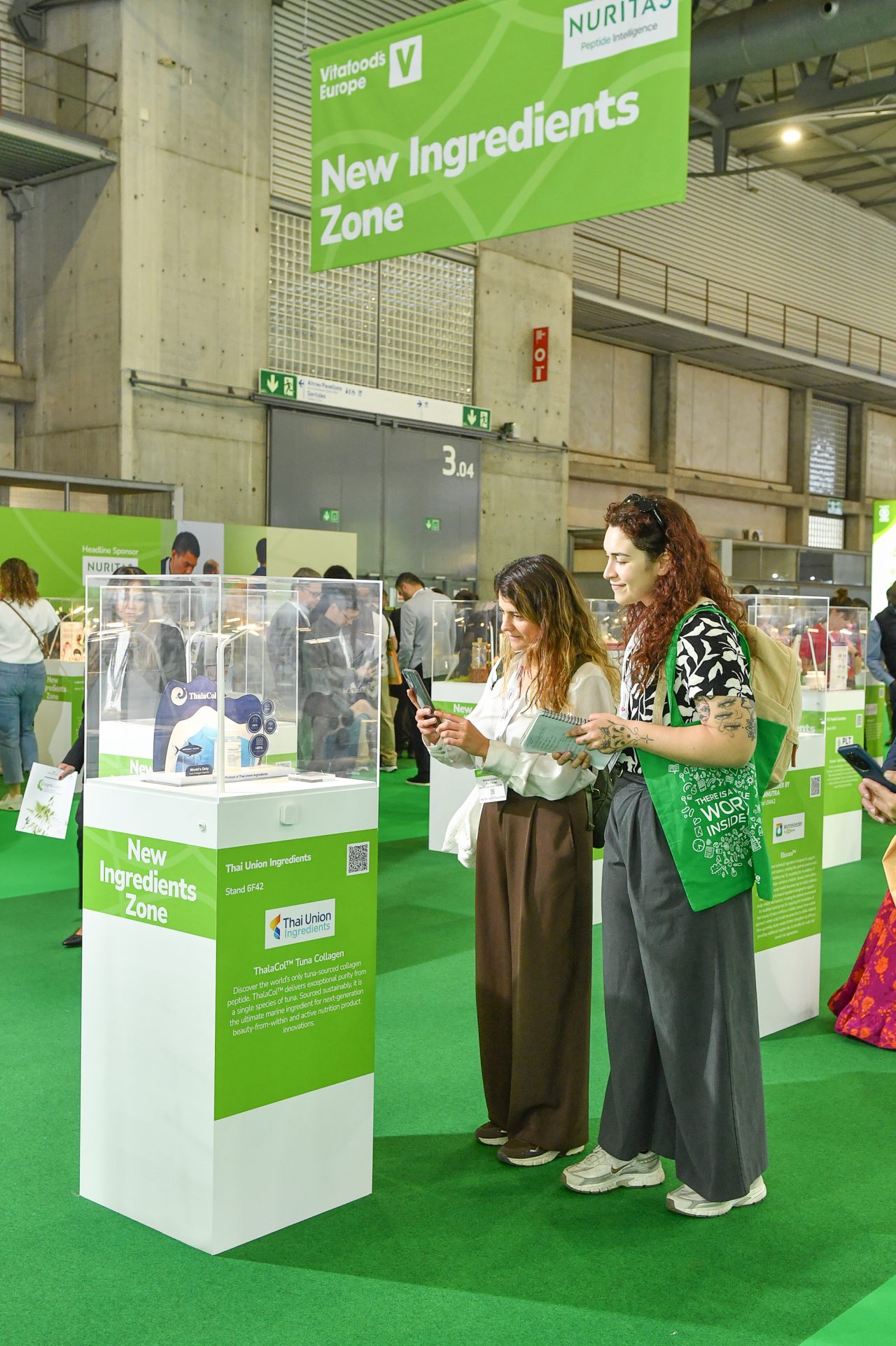 visitors listening to an exhibitor talking